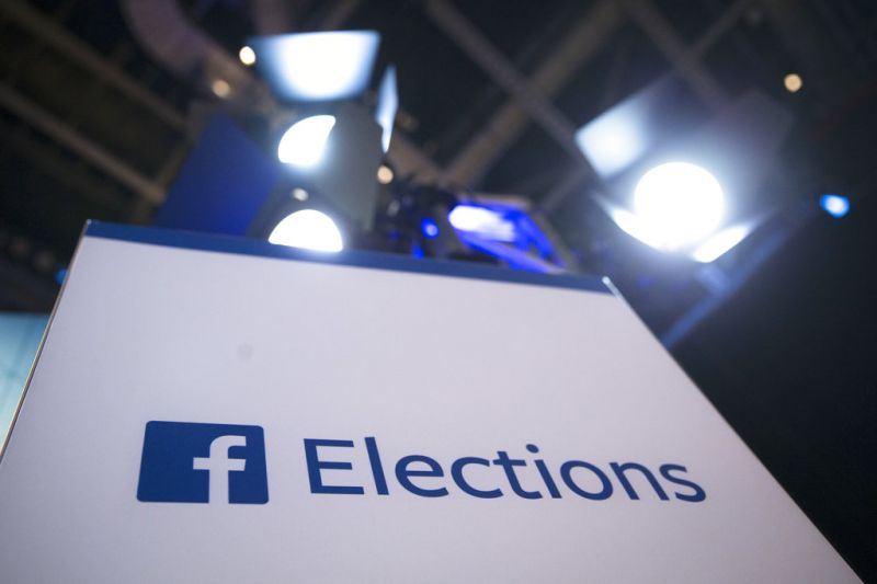 FILE- In this Aug. 6, 2015, file photo Facebook Elections signs stand in the media area in Cleveland before the first Republican presidential debate. The head of Trump-affiliated data-mining firm Cambridge Analytica was suspended on Tuesday, March 20, 2018, while government authorities are bearing down on both the firm and Facebook over allegations the firm stole data from 50 million Facebook users to manipulate elections. (AP Photo/John Minchillo, File)