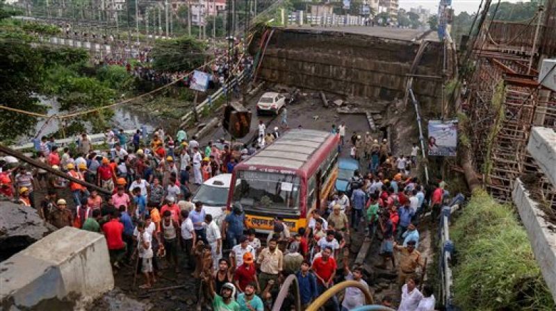 Vehicles are seen stuck after a section of Majerhat bridge collapsed in Kolkata, Tuesday. (Photo: PTI)