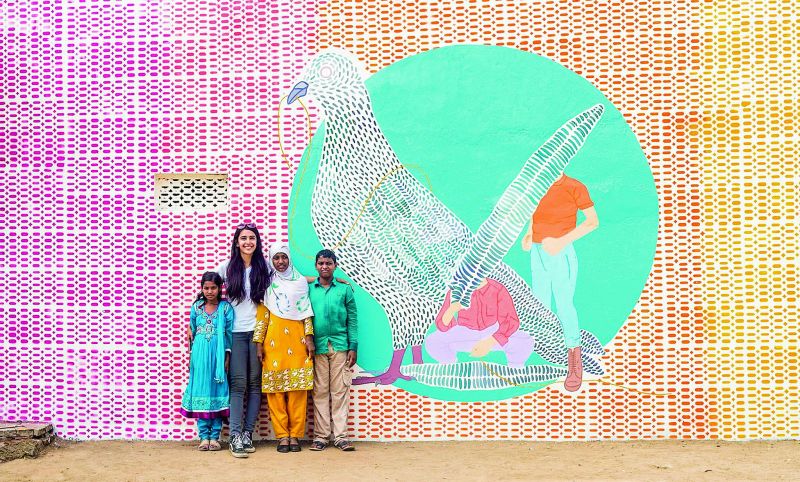 Happy faces: Artist sattired with children from the Makta region.