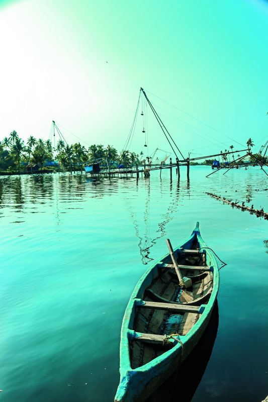 A boat tied to the shore at Kadamakudy Island in Kerala.