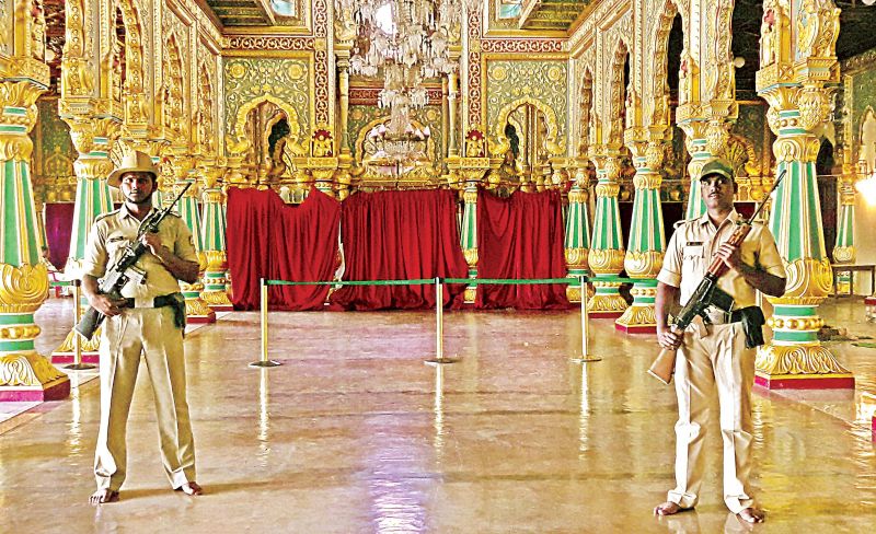 Policemen guard the Golden Throne which has been assembled for the private darbar of the scion of the Mysuru royal family during the Dasara festivities