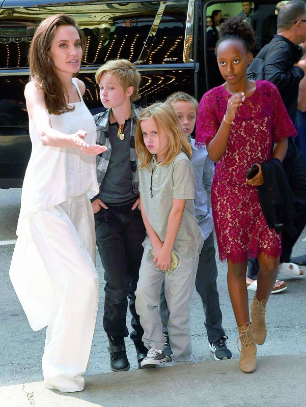 Angelina Jolie's daughter Shiloh Jolie-Pitt (centre) dresses as a boy