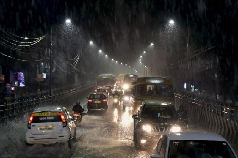 Vehicles move through a waterlogged road as heavy rains lash Chennai. (Photo: PTI)