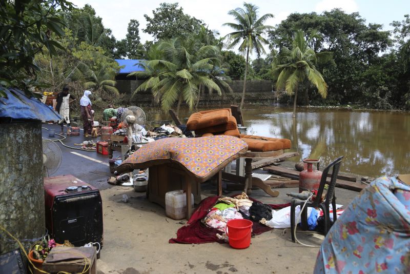 Household goods are placed on road to dry after being salvaged by residents from their flood affected houses on the outskirts of Kochi. (Photo: AP)