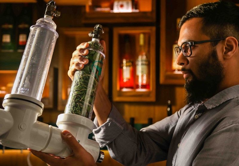 Resident beer geek Abhishek Chinchalkar holds a Randall filled with rosemary and basil at the Woodside Inn in Mumbai