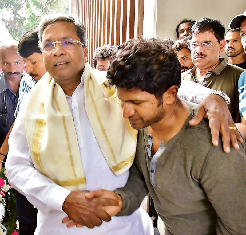 Chief Minister Siddaramaiah consoles actor Puneeth Rajkumar, as he arrives to pay his last respects to his mother Parvathamma Rajkumar, in Bengaluru on Wednesday. (Photo: DC)