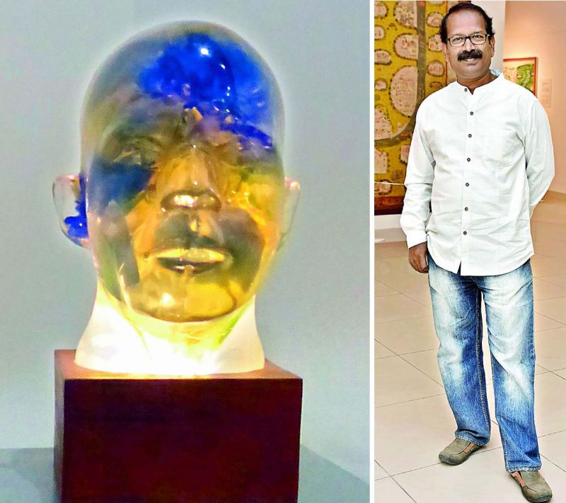 A striking sculpture in mixed media by Chippa Sudhakar is a composed head that's lit up intrinsically from the lower section.
