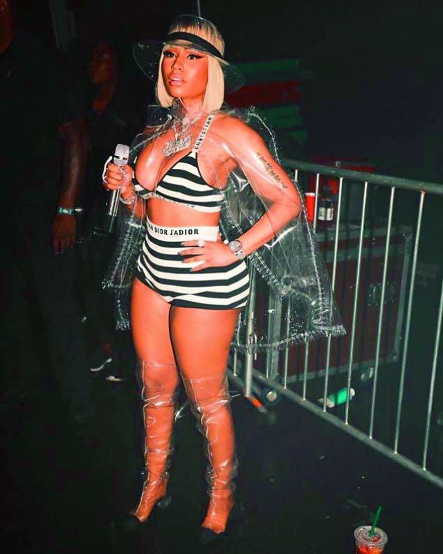 Rapper Nicki Minaj in a transparent jacket and thigh-high plastic boots.