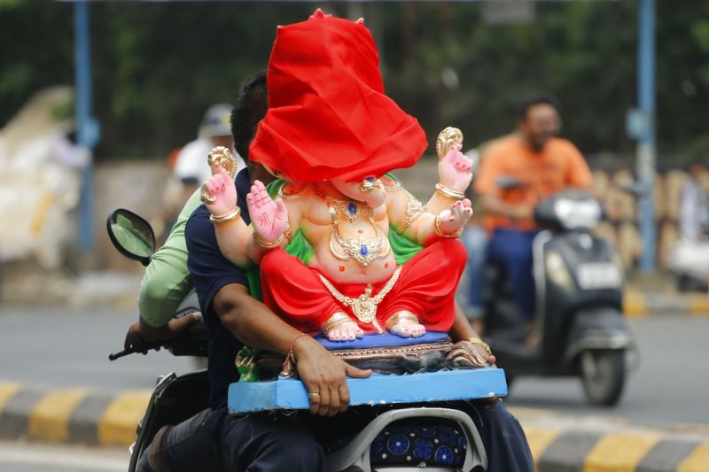 Devotees transport an idol of elephant-headed Hindu God Ganesha to a place of worship for Ganesh Chaturthi festival in Ahmadabad. (Photo: AP)