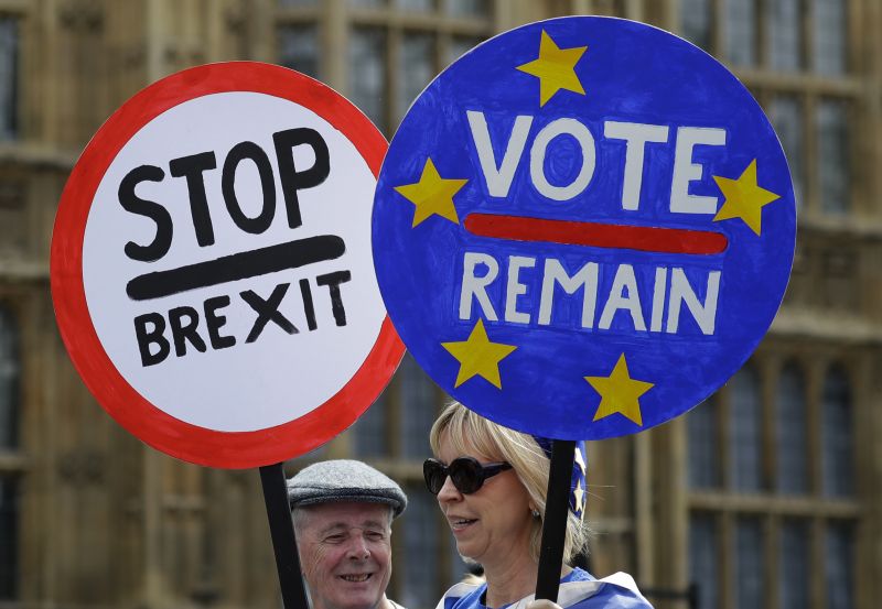 Anti Brexit campaigners hold banners near Parliament in London, Wednesday, May 22, 2019. British Prime Minister Theresa May was under pressure Wednesday to scrap a planned vote on her tattered Brexit blueprint and to call an end to her embattled premiership after her attempt at compromise got the thumbs-down from both her own Conservative Party and opposition lawmakers. (AP Photo/Kirsty Wigglesworth) 