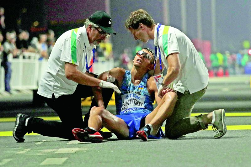 Maryan Zakalnytskyy of Ukraine collapses after finishing the menâ€™s 50 kilometre race walk at the World Athletics Championships in Doha on Sunday. (Photo: AP)