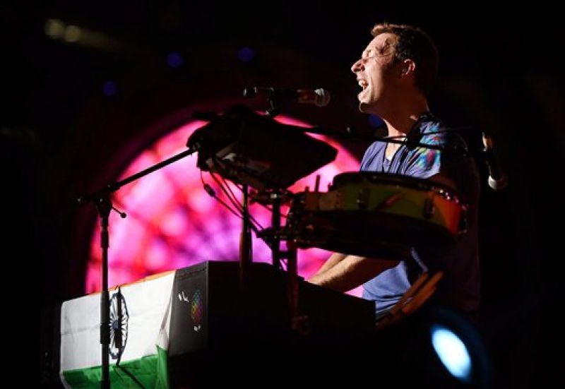  Chris Martin sings at the concert and the Indian flag can be seen in the picture. (Photo: PTI)