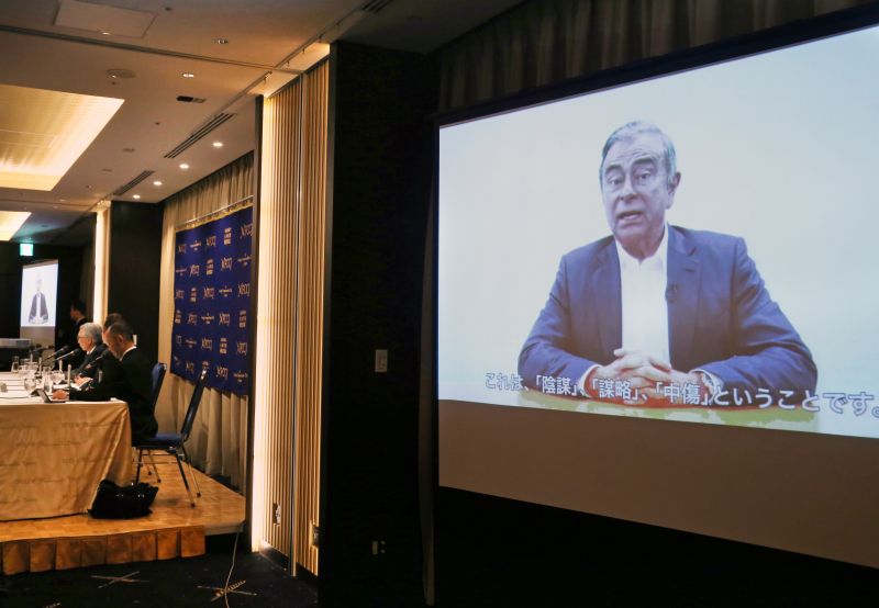 Former Nissan chairman Carlos Ghosn, seen on a screen, speaks in a video during a press conference held by his lawyers in Tokyo