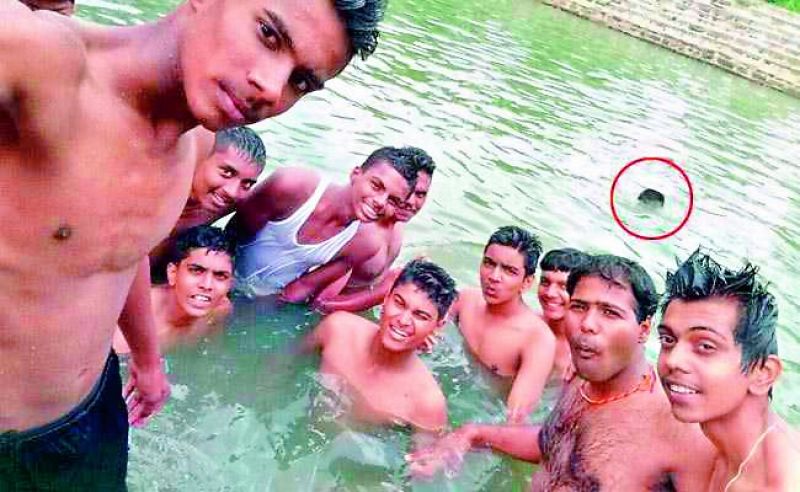 Sept. 26, 2017: A 17-year-old student drowns (circled) in a pond near Karnataka's Kanakapura, while his unmindful friends are busy taking a group selfie.