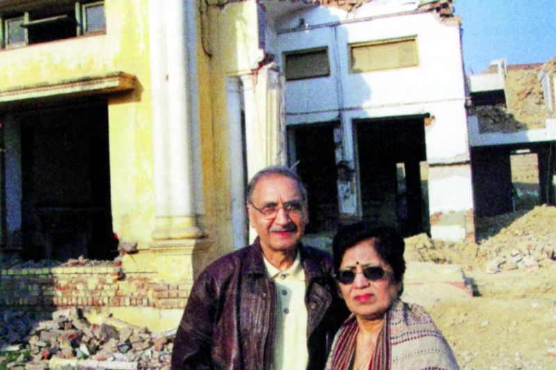 Narendra Luther with his wife, Bindi, in front of his ancestral house in Lahore