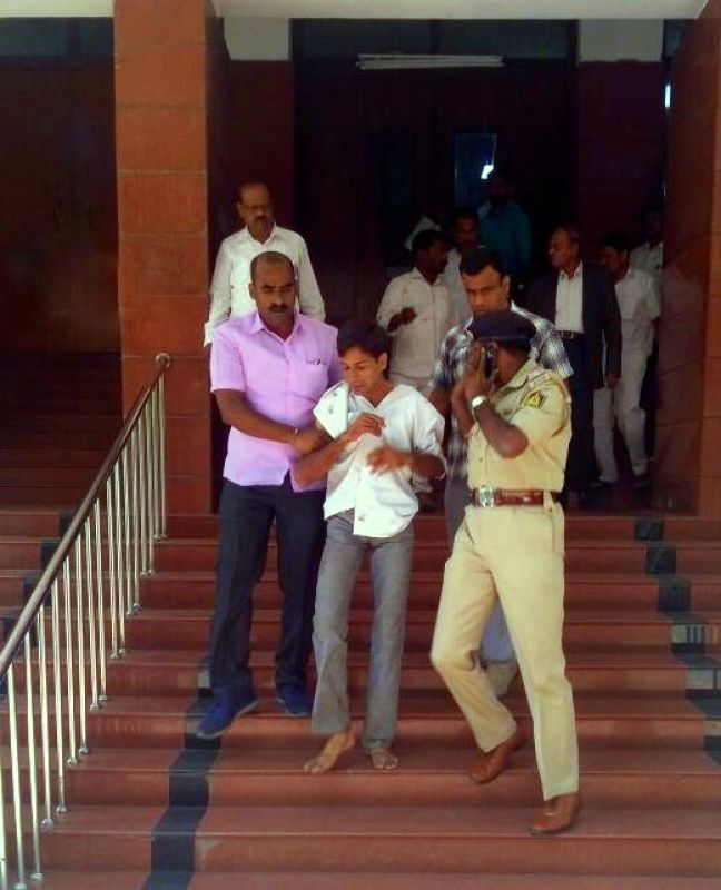 Attacker Tejas Sharma who stabbed the Karnataka Lokayukta Justice Vishwanath Shetty at his office in Bengaluru has been taken into custody by the police. (Photo: ANI | Twitter)