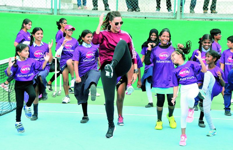 Bollywood actress Neha Dhupia dances with the kids at the WTA Future Stars clinic.