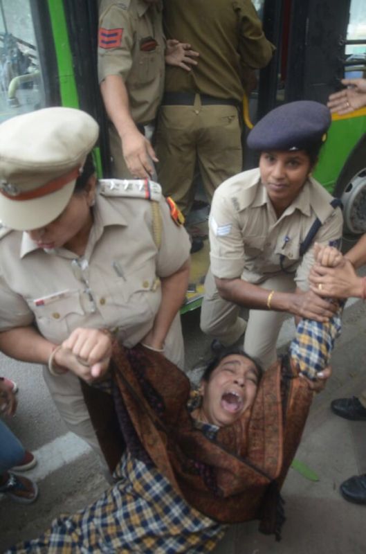 Najeeb Ahmed's mother being dragged away by Delhi police. (Photo: Twitter)