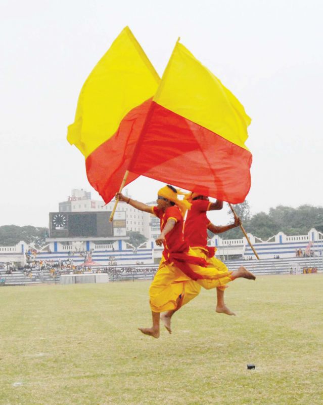Rajyotsava performers with the Kannada flag