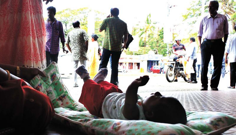 A baby relaxes in South Railway station in Ernakulam even as her family members were forced to stay inside the platform due to non-availability of vehicles. (Photo: DC)