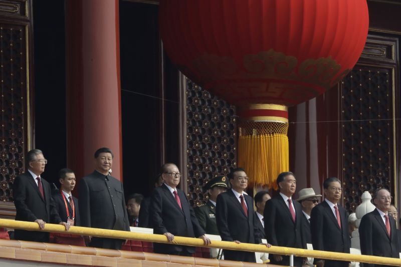 Chinese President Xi Jinping, third from left, stands with other Chinese leaders to watch a parade as Communist Party celebrates its 70th anniversary in Beijing. (Photo: AP)