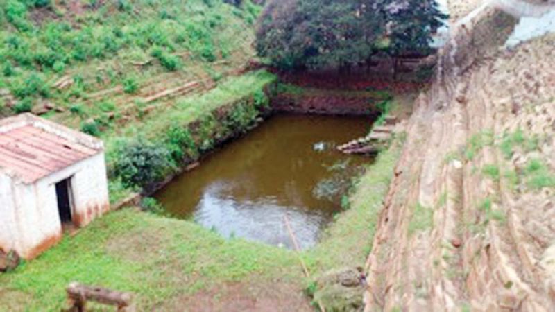 The temple Gopuram and temple pond, now polluted with mining dust.