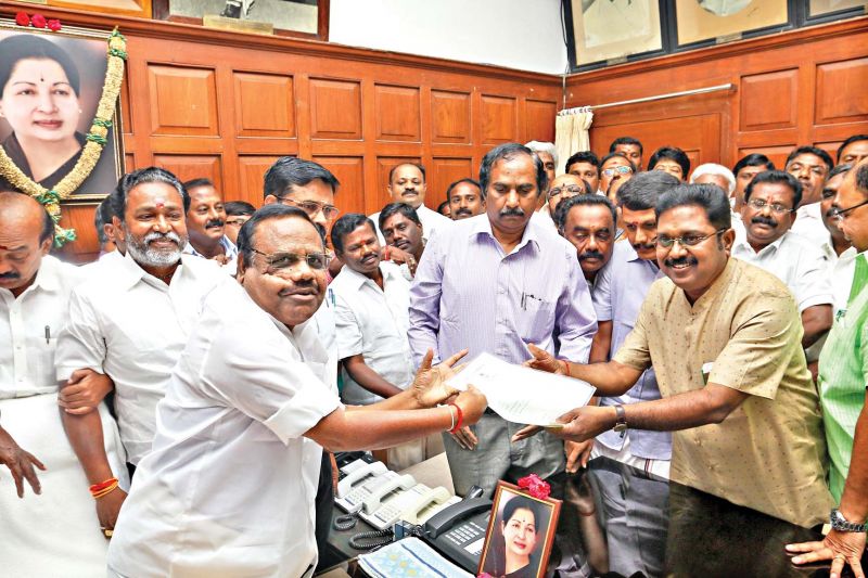Speaker P.Dhanapal swears in T.T.V. Dhinakaran as R.K. Nagar MLA in his chamber at the secretriat in the city on Friday. (Photo: DC)