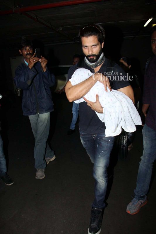 Snapped: Shahid keeps Misha away from paparazzi as they return from holiday