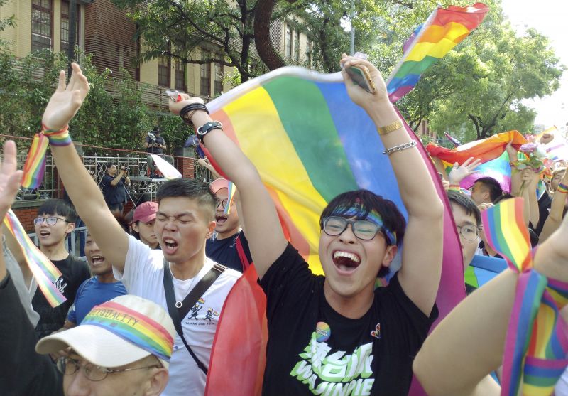 Same-sex marriage supporters cheer outside the Legislative Yuan Friday, May 17, 2019, in Taipei, Taiwan after the legislature passed a law allowing same-sex marriage in a first for Asia. The vote Friday allows same-sex couples full legal marriage rights, including in areas such as taxes, insurance and child custody. (AP Photo/Chiang Ying-ying) 