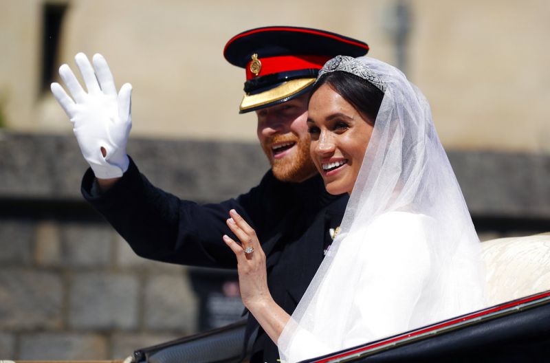 Britain's Prince Harry and his wife Meghan Markle ride a horse-drawn carriage, after their wedding ceremony. (Photo: AP)