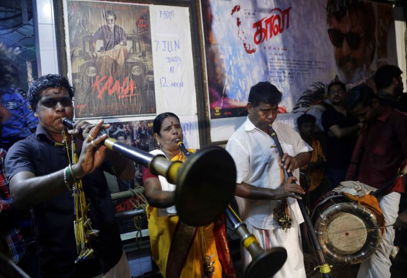 Musicians perform inside a cinema hall during 'Kaala' movie release, the new movie of superstar Rajinikanth, in Mumbai. (Photo: AP)