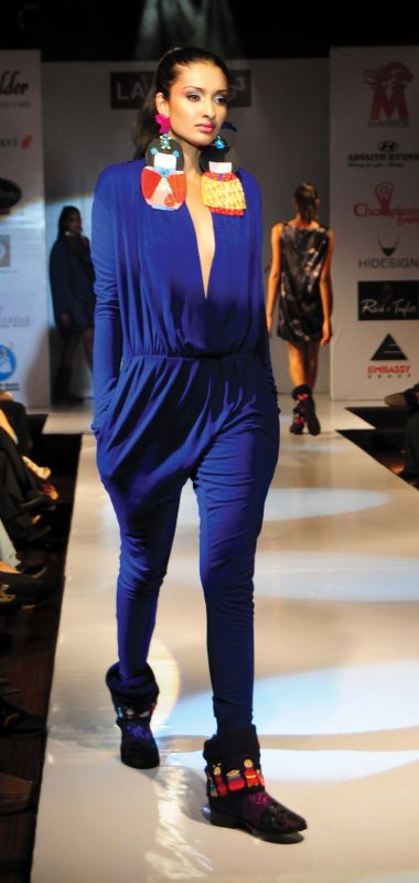 This navy jumpsuit is accessorised with just  earrings.