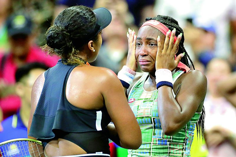 Coco Gauff (right) of USA wipes away tears while talking to Naomi Osaka of Japan after their US Open third round match in New York on Saturday. (Photo: AP) 