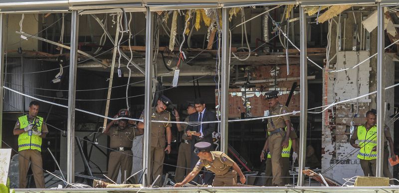 A Sri Lankan Police officer inspects a blast spot at the Shangri-la hotel in Colombo, Sri Lanka. (Photo:AP)