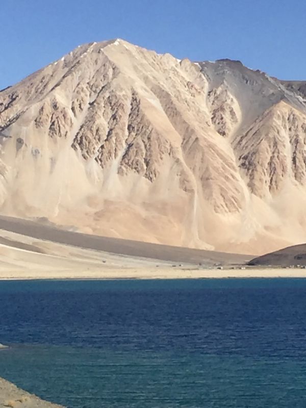 Pangong lake stretches to Tibet. The snow peaks in the distance are seen all through the year