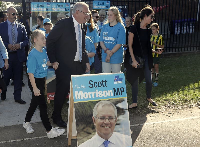 Australian Prime Minister Scott Morrison, center, leaves a polling station after casting his ballot in a federal election in Sydney, Australia, Saturday, May 18, 2019. Both major parties are promising that whoever wins the election the leader will remain prime minister until he next faces the voters' judgment. The parties have changed their rules to make the process of lawmakers replacing a prime minister more difficult. (AP Photo/Rick Rycroft)