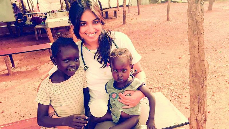 Shiny poses with kids during one of her camps in Africa