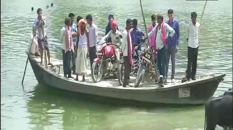 Surrounded by river Budhigandak on three sides, the village in Begusarai district has a single road which connects it to the rest of the state. (Photo: ANI)