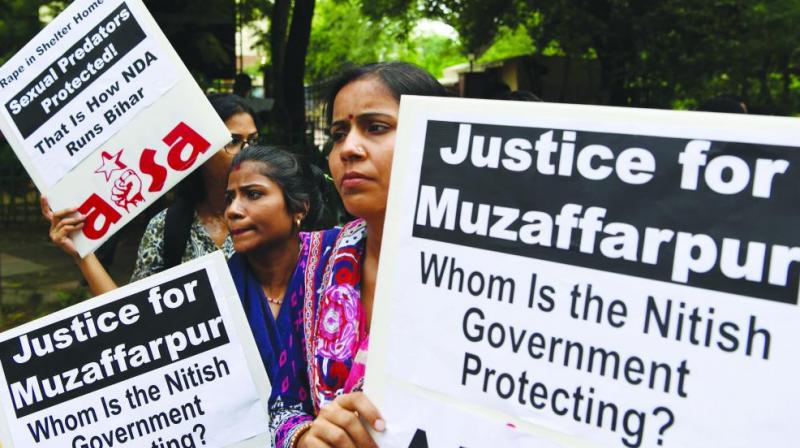 Women rights activists protest in New Delhi on July 30 over the sexual assault of girls at a state-funded shelter home in Muzaffarpur district, Bihar. Police dug up the grounds of the rescue home after allegations that one girl was killed there.