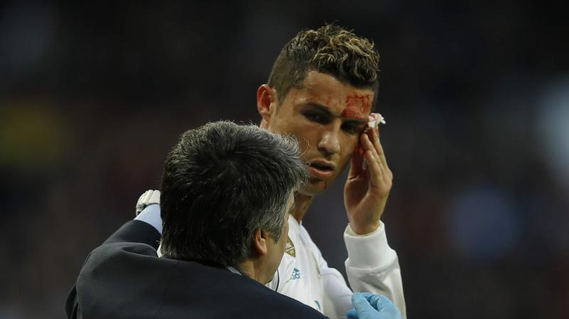 Using the phone camera as a mirror, Cristiano Ronaldo checked the damage and was not happy with what he saw, shaking his head briefly. (Photo: AP)