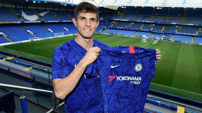 Christian Pulisic poses in Chelsea shirt after completing move from Dortmund