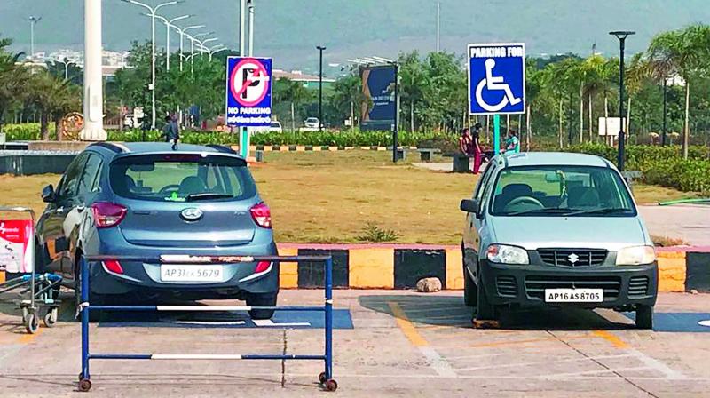 Cars chained for parking at the space reserved for physically challenged persons at Visakhapatnam Airport on Tuesday. (Photo: DC)
