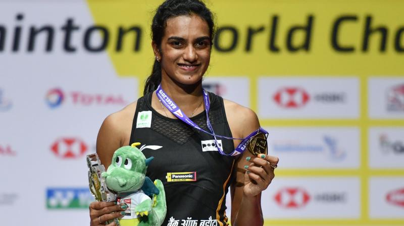 PV Sindhu won the BWF World Championships title by defeating Japans Nozomi Okuhara in straight games by 21-7, 21-7. (Photo: AFP)
