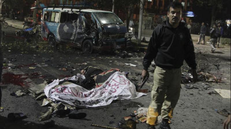 A police commando stands alert at the site of a deadly bombing, in Lahore, Pakistan. (Photo: AP)