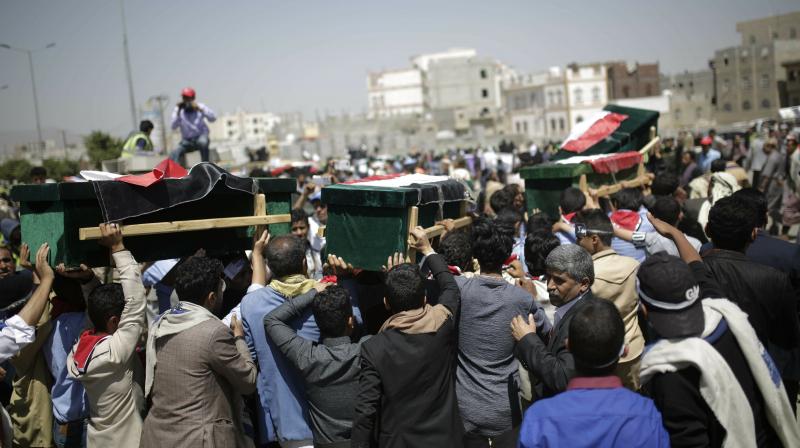 Crowds of men spilled into the streets of the capital where coffins draped with Yemeni flags were lined up. (Photo:AP)