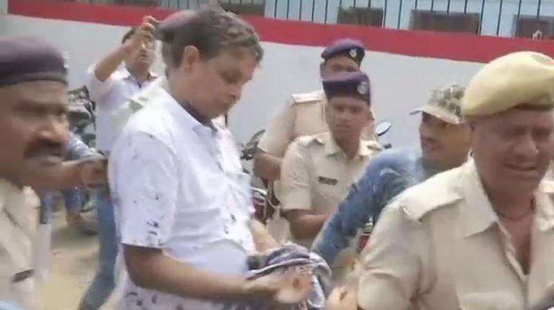 A woman threw ink at Brajesh Thakur outside the court on Wednesday. (Photo: ANI | Twitter)