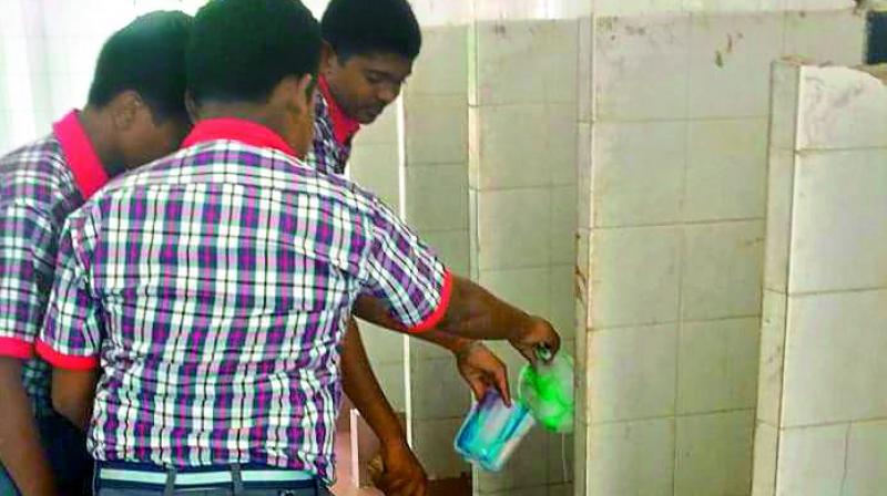 KV students cleaning toilets without precautionary measures such as gloves or masks.