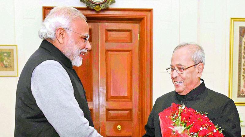 President Pranab Mukherjee is greeted by Prime Minister Narendra Modi on the occasion of the New Year 2017 at Rashtrapati Bhavan in New Delhi on Sunday. (Photo: PTI)
