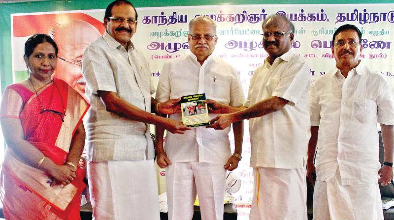 Judge, Madras high court, Justice N. Kirubakaran releasing a book named Aluvathu Alagalla Penne, a compilation of legislation relating to harassment women and children, by advocate A.P. Suryaprakasam in Chennai on Sunday. Senior Congress leader and former MP Peter Alphonse receive the book from the justice. Justice K.N. Basha, a retired judge of the Madras HC and Suryaprakasam are also seen in the photo.(DC)