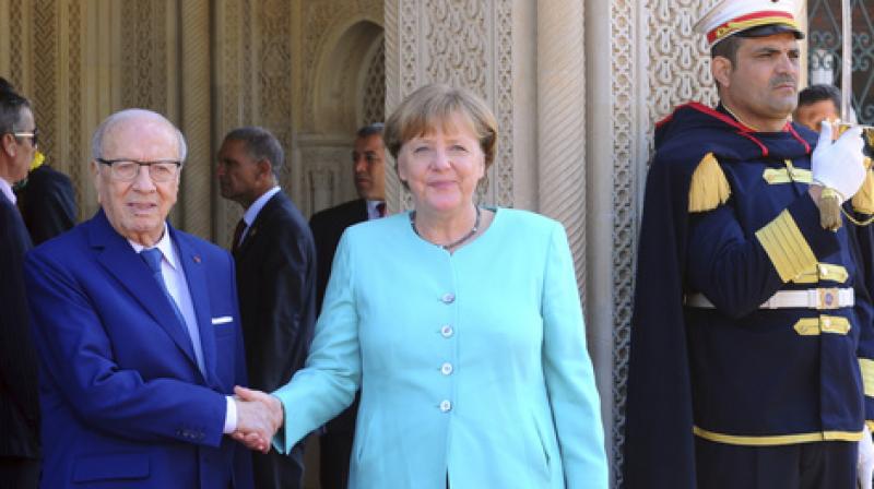 Tunisian President Beji Caid Essebsi, left, shakes hands with German Chancellor Angela Merkel, prior to their meeting at the presidential palace in Carthage, near Tunis, Tunisia. (Photo: AP)